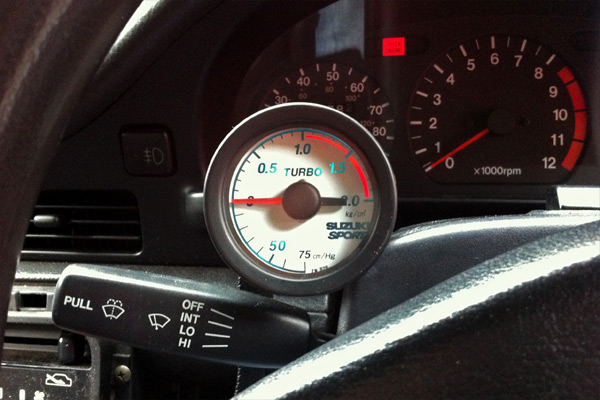 SuzukiSport Boost Gauge mounted on a Cappuccino steering column